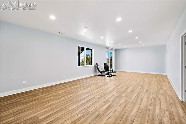 exercise area with light wood-type flooring