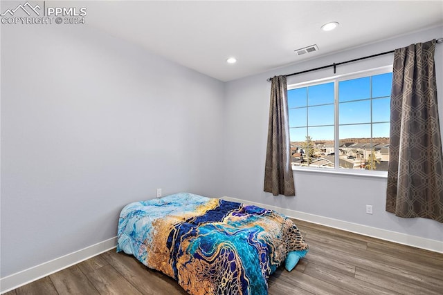 bedroom with hardwood / wood-style flooring