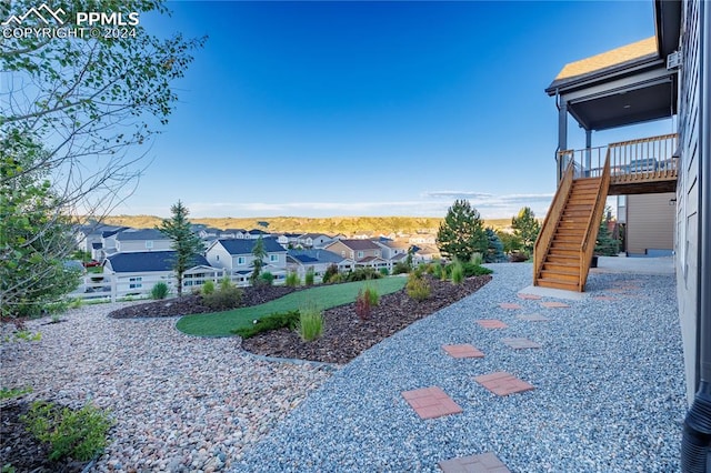 view of yard with a wooden deck and a patio