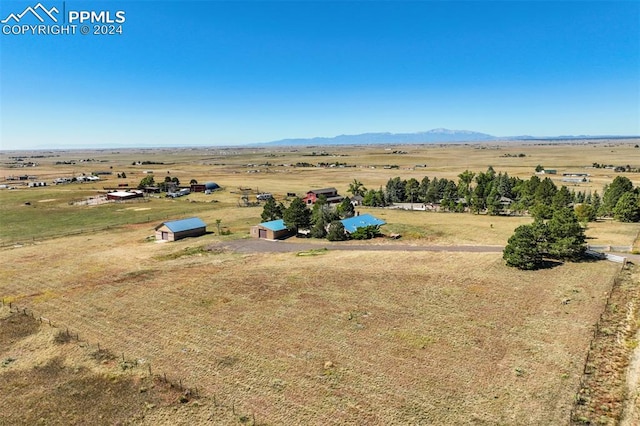 birds eye view of property featuring a mountain view and a rural view