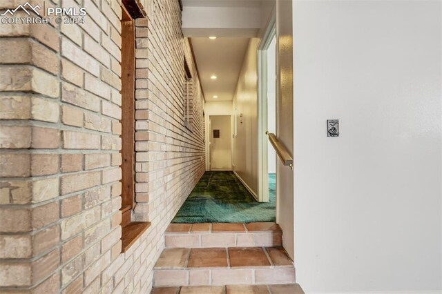 hallway with brick wall