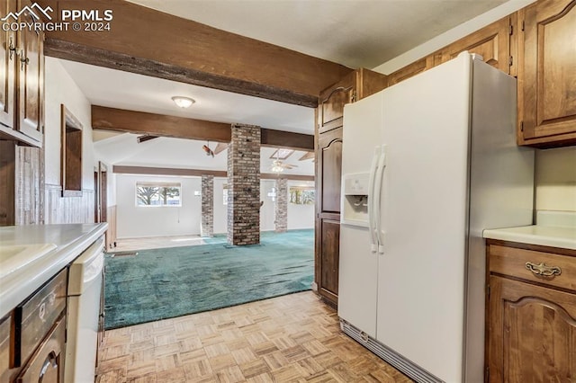 kitchen with light parquet flooring, decorative columns, white appliances, and beamed ceiling