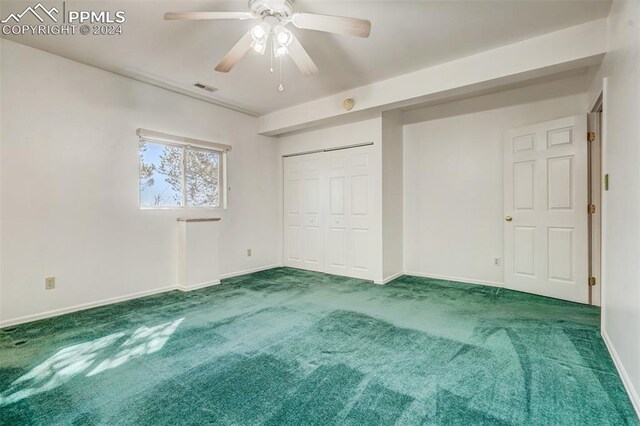 unfurnished bedroom with a closet, ceiling fan, and carpet flooring