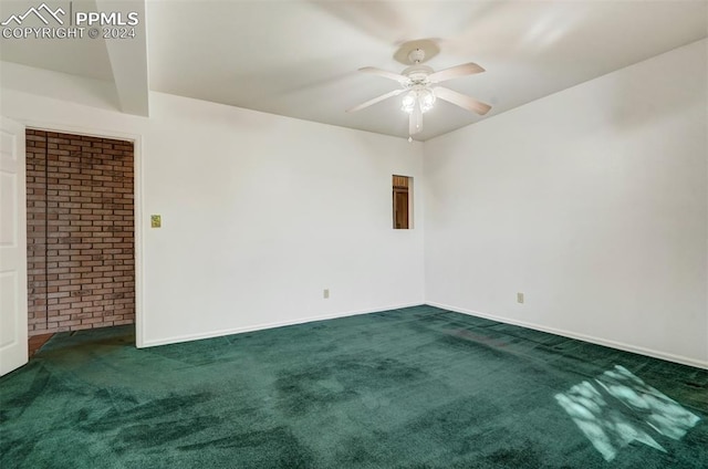 unfurnished room featuring dark colored carpet and ceiling fan