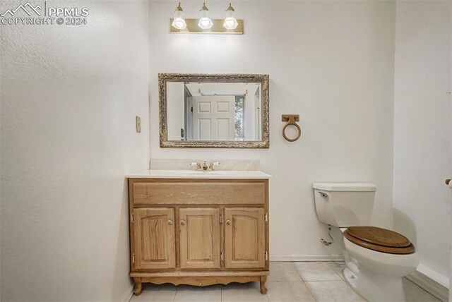 bathroom with vanity, toilet, and tile patterned floors