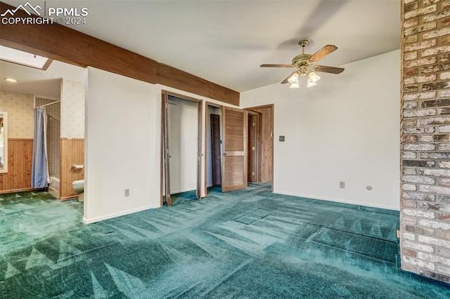 unfurnished bedroom with carpet, ceiling fan, and ensuite bathroom