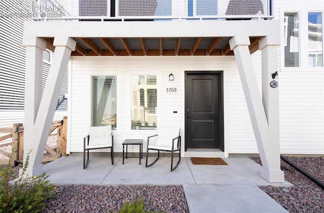 doorway to property with a balcony and a patio area