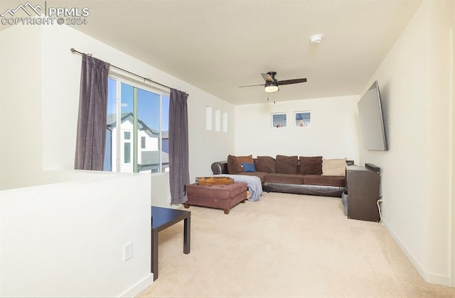 carpeted living room featuring ceiling fan