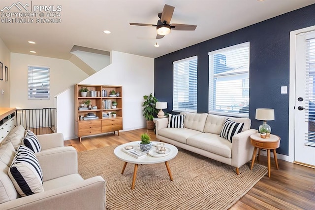 living room featuring ceiling fan and hardwood / wood-style flooring