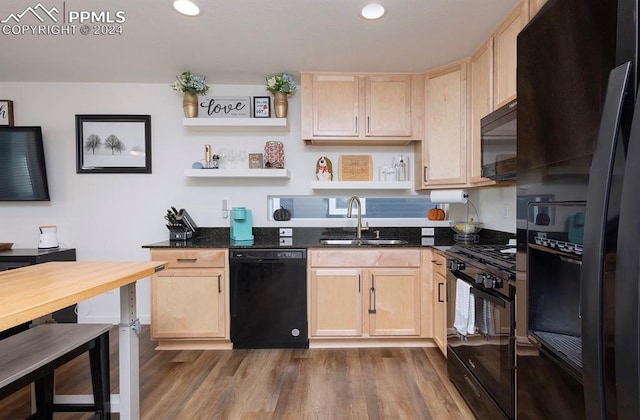 kitchen featuring black appliances, light brown cabinetry, sink, and dark hardwood / wood-style flooring