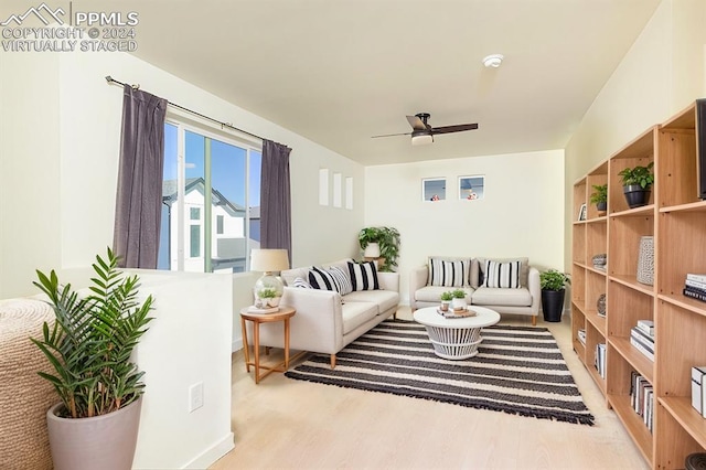 living area with ceiling fan