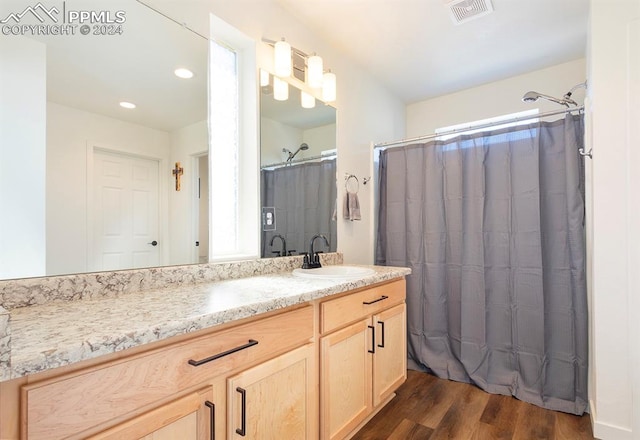 bathroom featuring a shower with curtain, vanity, and hardwood / wood-style flooring