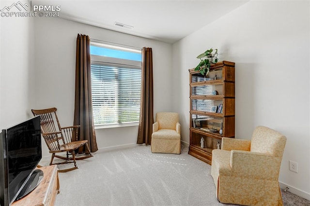 living area featuring carpet floors