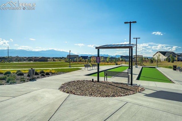 view of community with a yard and a mountain view