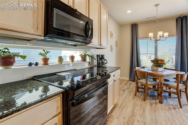 kitchen featuring pendant lighting, dark stone counters, light hardwood / wood-style flooring, a notable chandelier, and black appliances