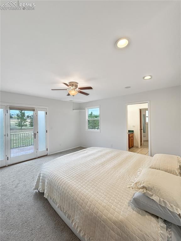 bedroom featuring ceiling fan, light colored carpet, and access to exterior