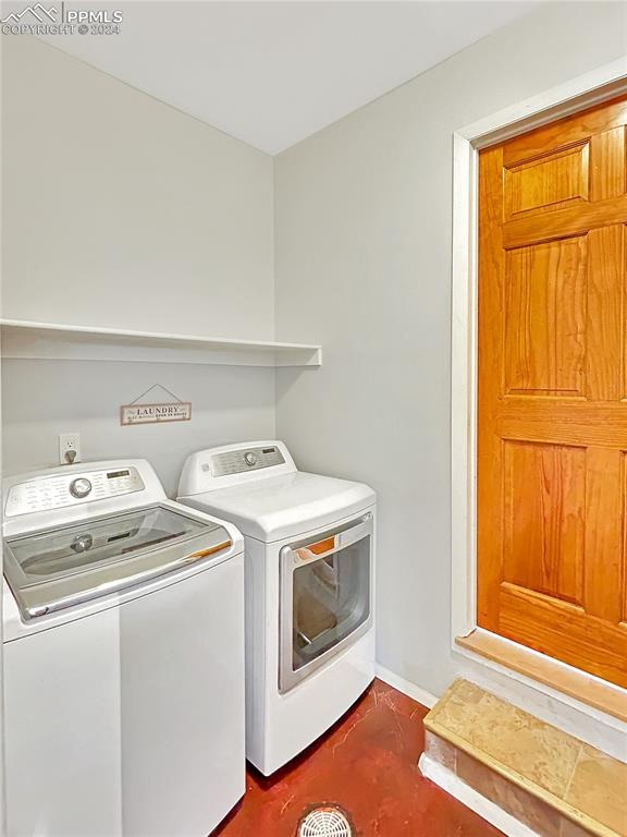 clothes washing area featuring independent washer and dryer