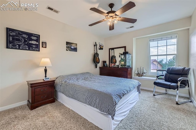 bedroom with ceiling fan and light colored carpet