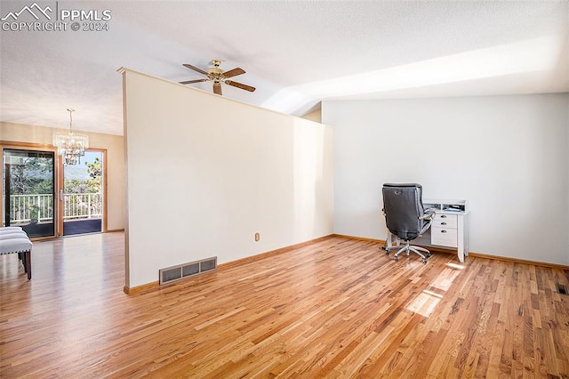 unfurnished office featuring light wood-type flooring, ceiling fan with notable chandelier, and vaulted ceiling