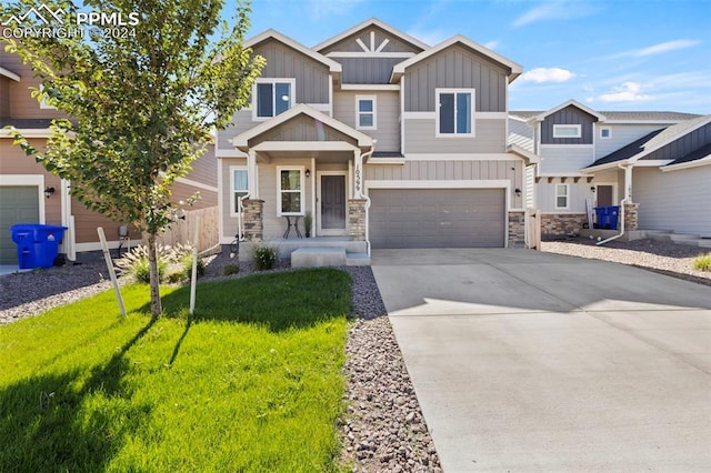 craftsman-style home featuring a front yard and a garage