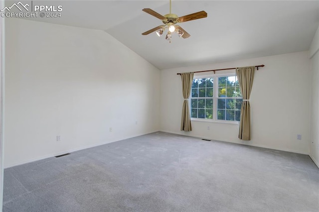 spare room featuring ceiling fan, vaulted ceiling, and carpet