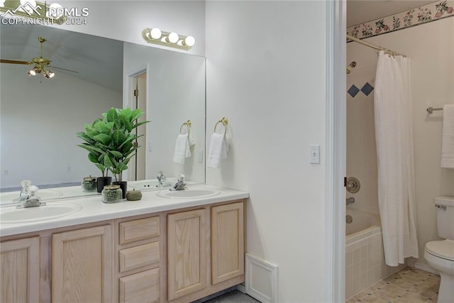 full bathroom with shower / bath combo with shower curtain, vanity, tile patterned flooring, ceiling fan, and toilet