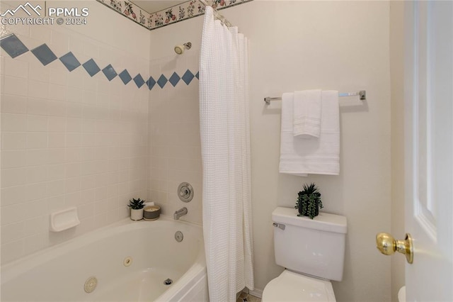 bathroom featuring shower / bathtub combination with curtain and toilet