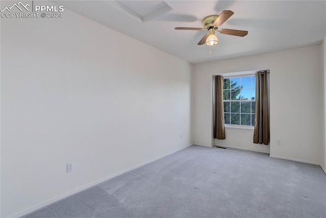 carpeted empty room featuring ceiling fan