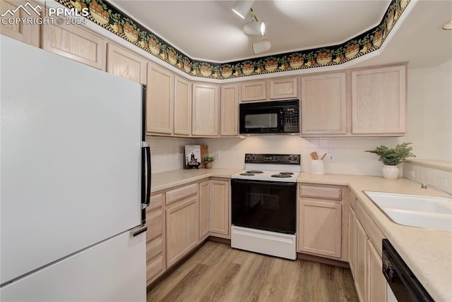 kitchen featuring light wood-type flooring, sink, decorative backsplash, white appliances, and light brown cabinets