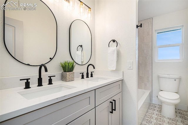 full bathroom with tiled shower / bath combo, tile patterned flooring, vanity, and toilet