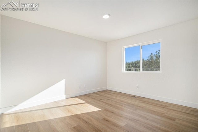 spare room with light hardwood / wood-style flooring