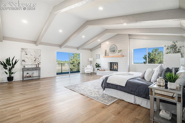 bedroom with vaulted ceiling with beams, light hardwood / wood-style floors, access to outside, and a large fireplace