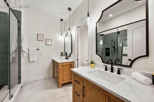 bathroom with tile patterned flooring, a shower with door, and vanity