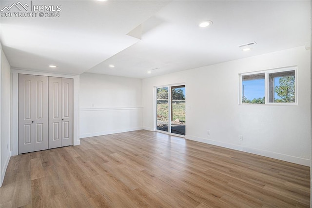 unfurnished room with light wood-type flooring