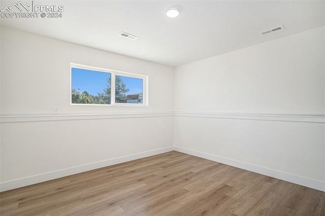 spare room with wood-type flooring