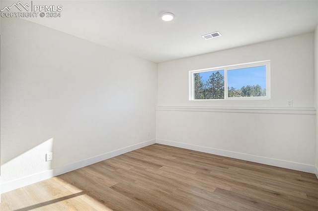 spare room with wood-type flooring