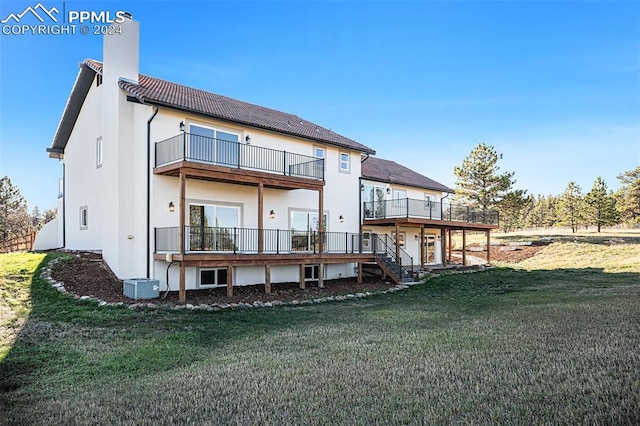 back of property featuring cooling unit and a lawn