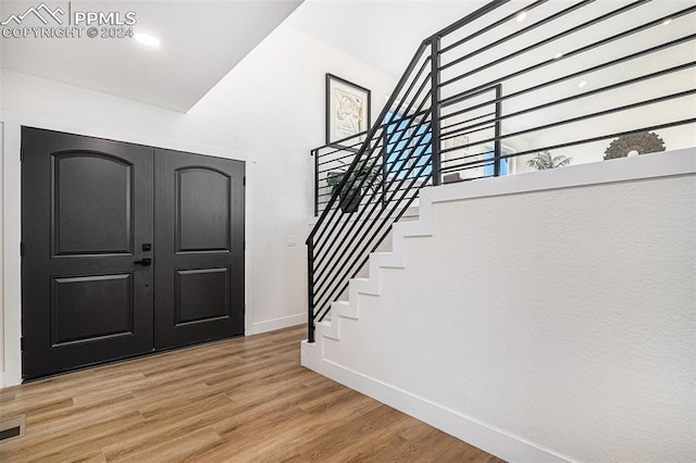 entryway with hardwood / wood-style floors