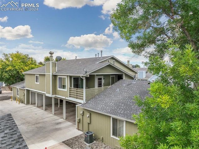 rear view of house with central AC unit and a patio area