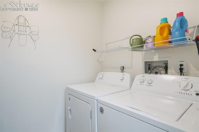 clothes washing area with washing machine and dryer