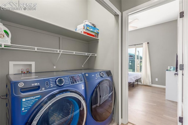 laundry room featuring light hardwood / wood-style flooring and independent washer and dryer