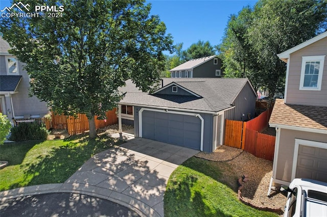 view of front of house with a front yard and a garage