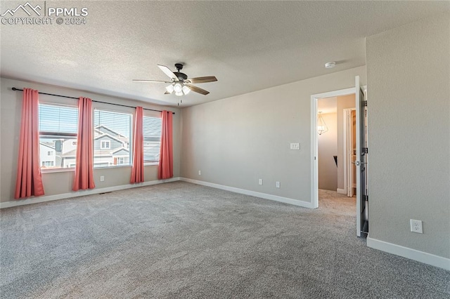 carpeted spare room with a textured ceiling and ceiling fan