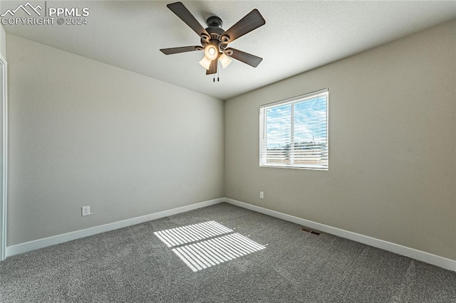 carpeted empty room featuring ceiling fan