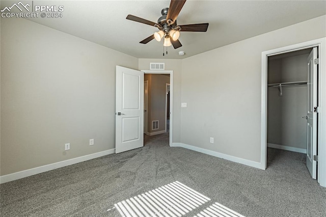 unfurnished bedroom featuring ceiling fan, a closet, and light carpet