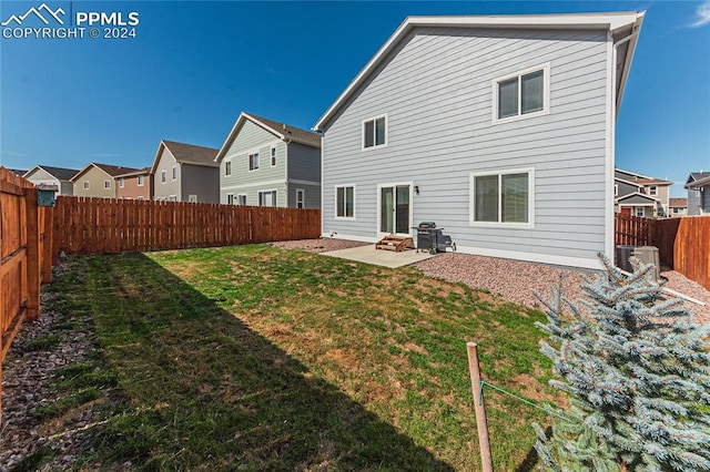 rear view of house featuring central AC, a patio area, and a yard