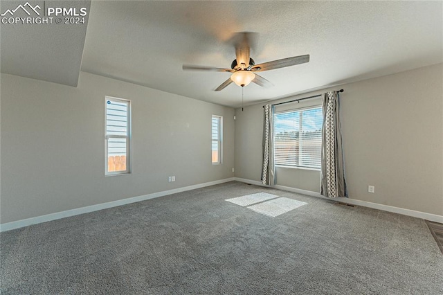 spare room featuring carpet floors, a textured ceiling, and ceiling fan