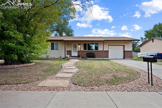 ranch-style house with a porch, a garage, and a front yard