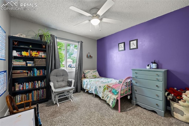 carpeted bedroom with ceiling fan and a textured ceiling