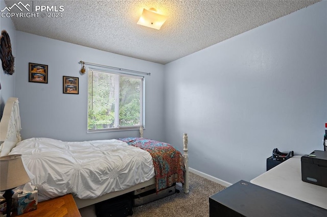 carpeted bedroom featuring a textured ceiling